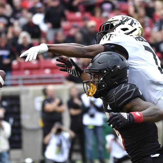 Wake Forest defensive back Gavin Holmes tips the ball away from Louisville wide receiver Ahmari Huggins Bruce.jpeg